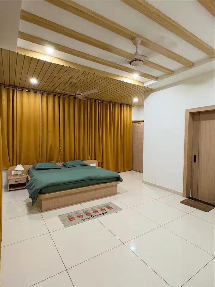 Bedroom 1 — AC bedroom with closet, attached washroom with geyser, and a study table with small sitting